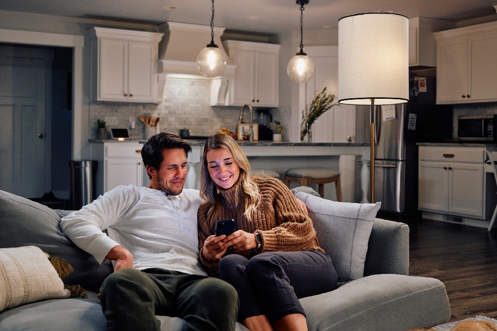 couple on couch looking at phone