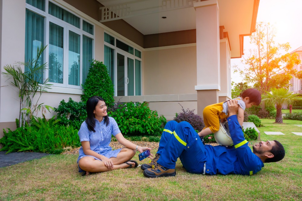 family on lawn outside of house