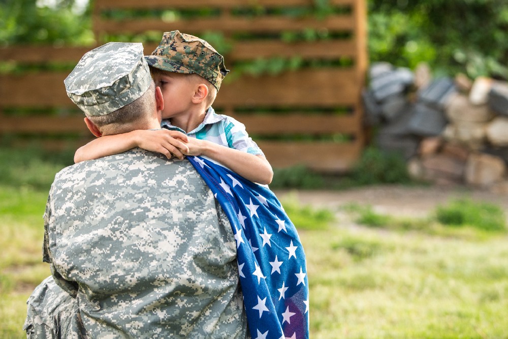 military dad hugging son