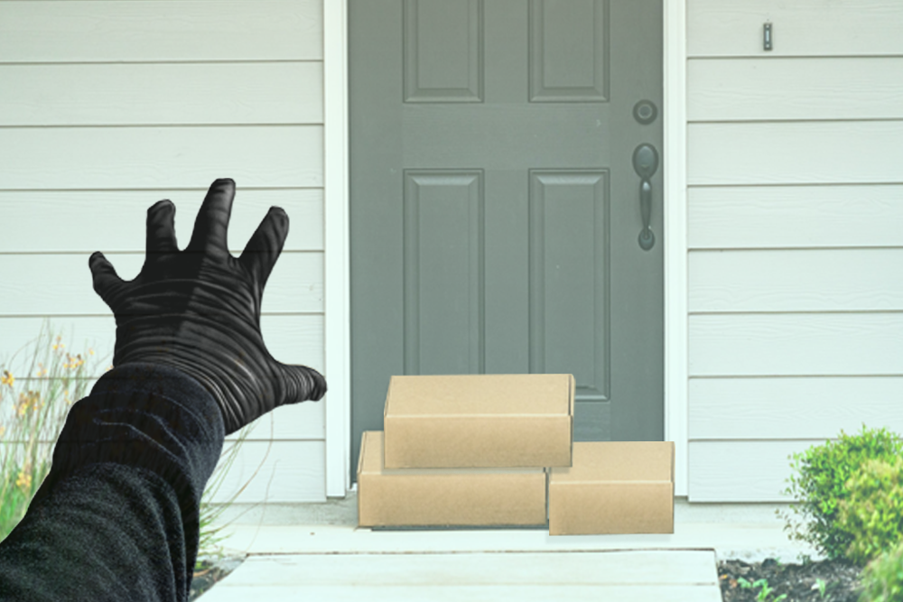 packages on front door and person with black glove reaching for them